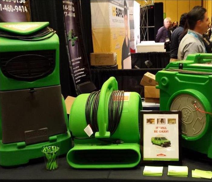AHMA Exhibit Table with green SERVPRO equipment on it