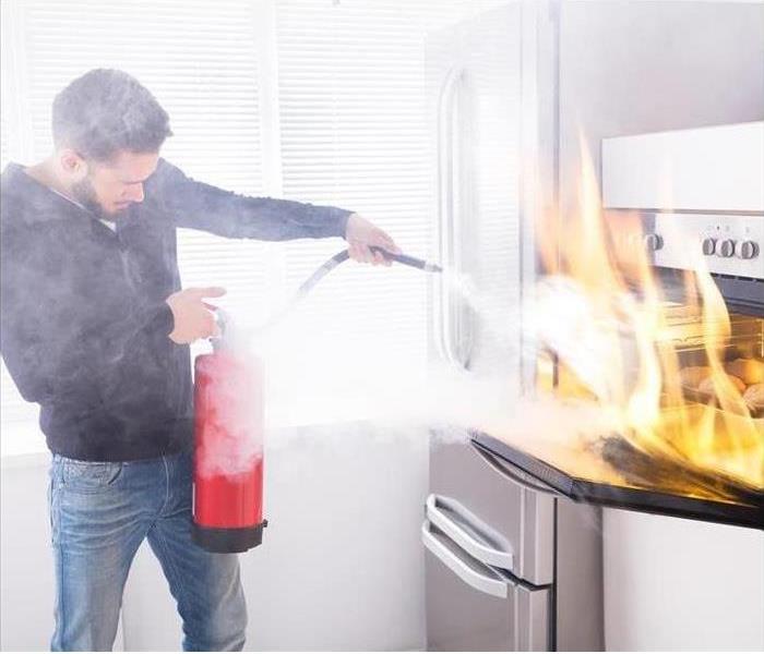 a picture of a man using a fire extinguisher 